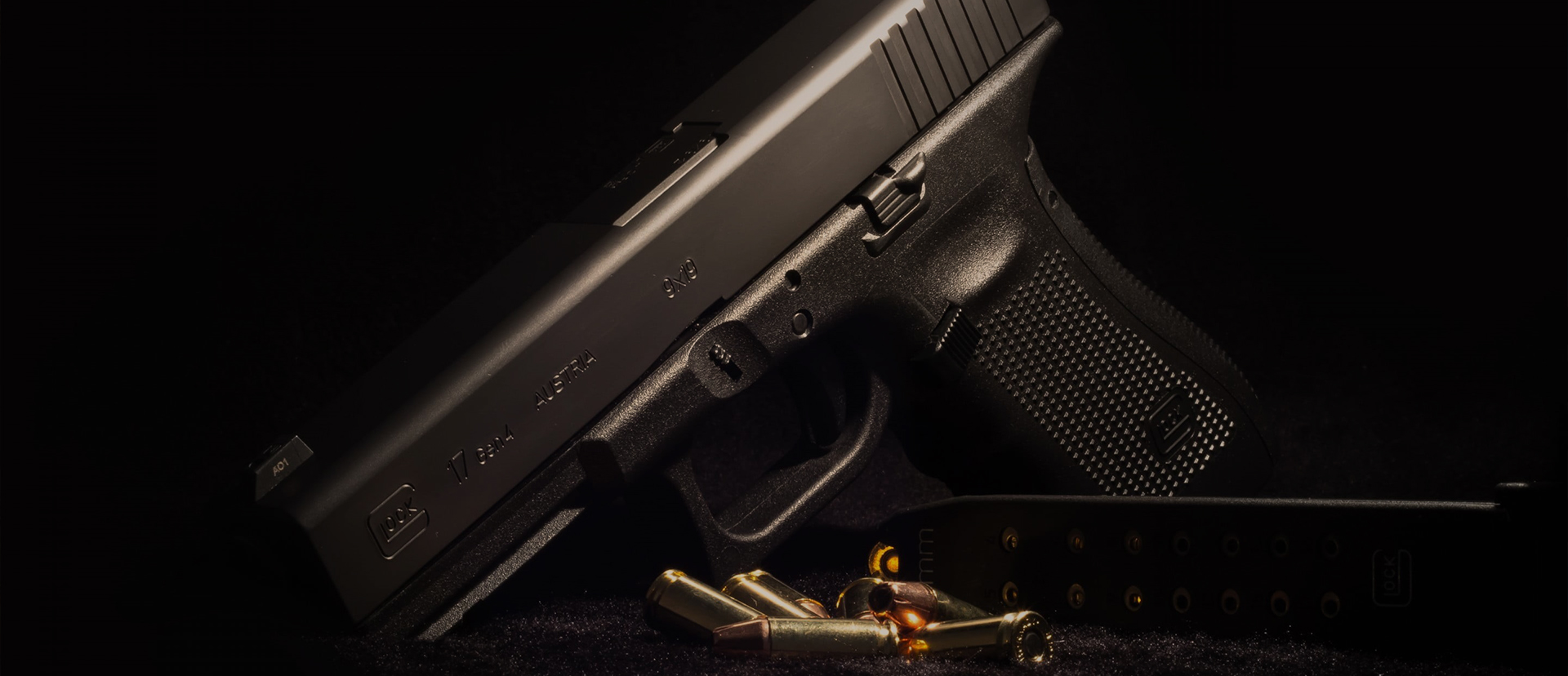 Dark handgun on moody, dark background