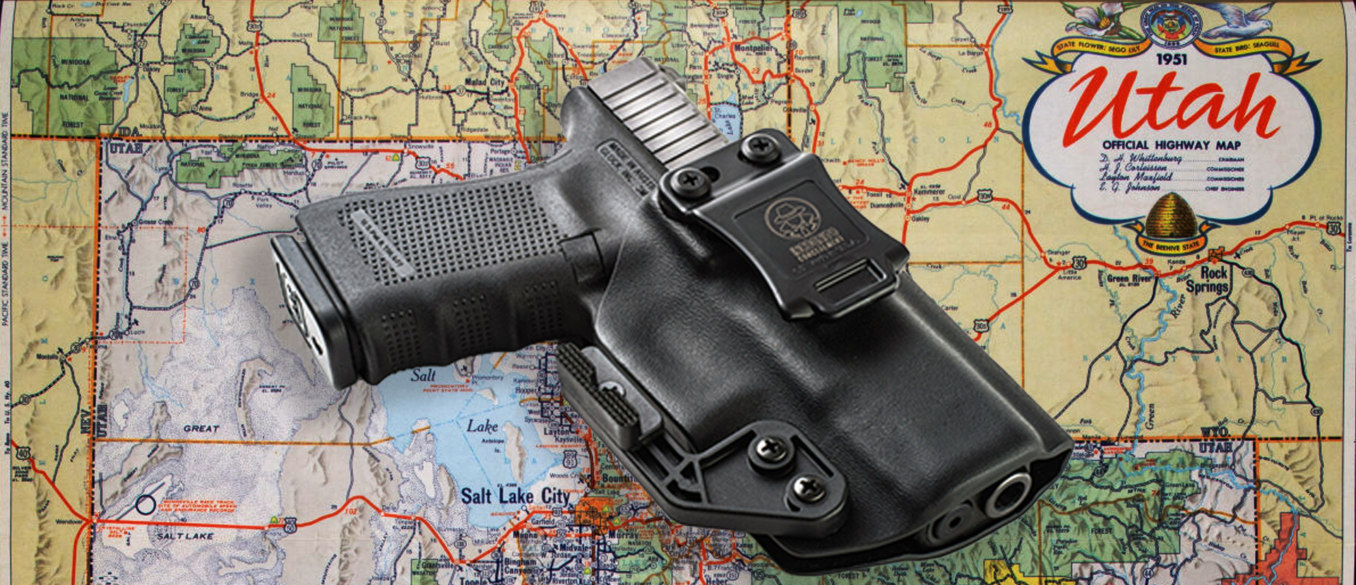 Map of Utah with a handgun laying on top of it