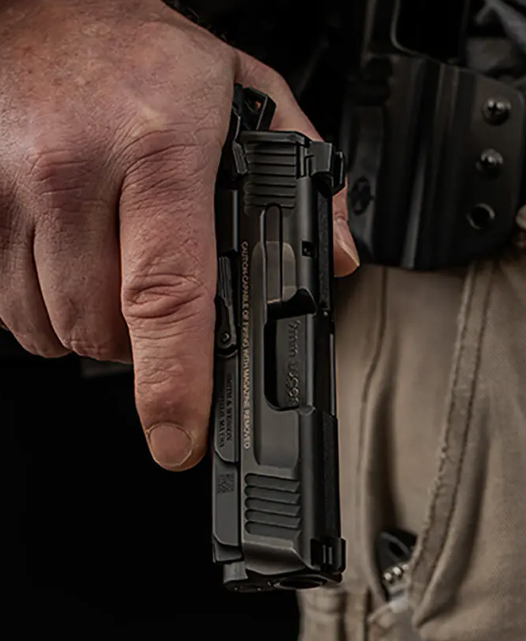 Man with a handgun held down by his hip