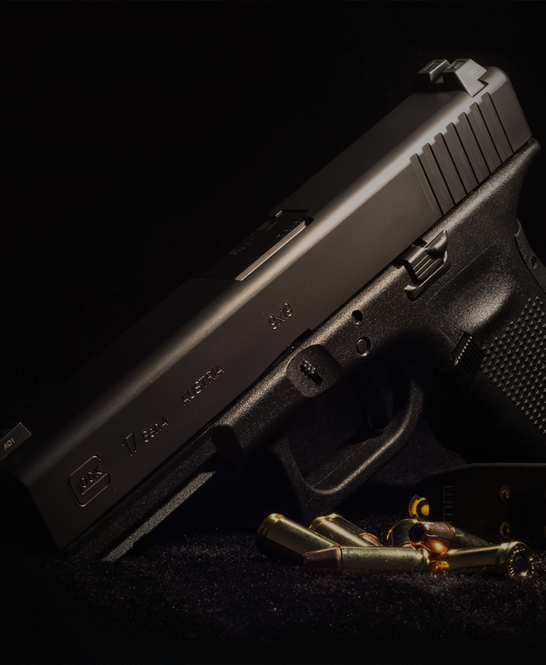 Dark handgun on moody, dark background