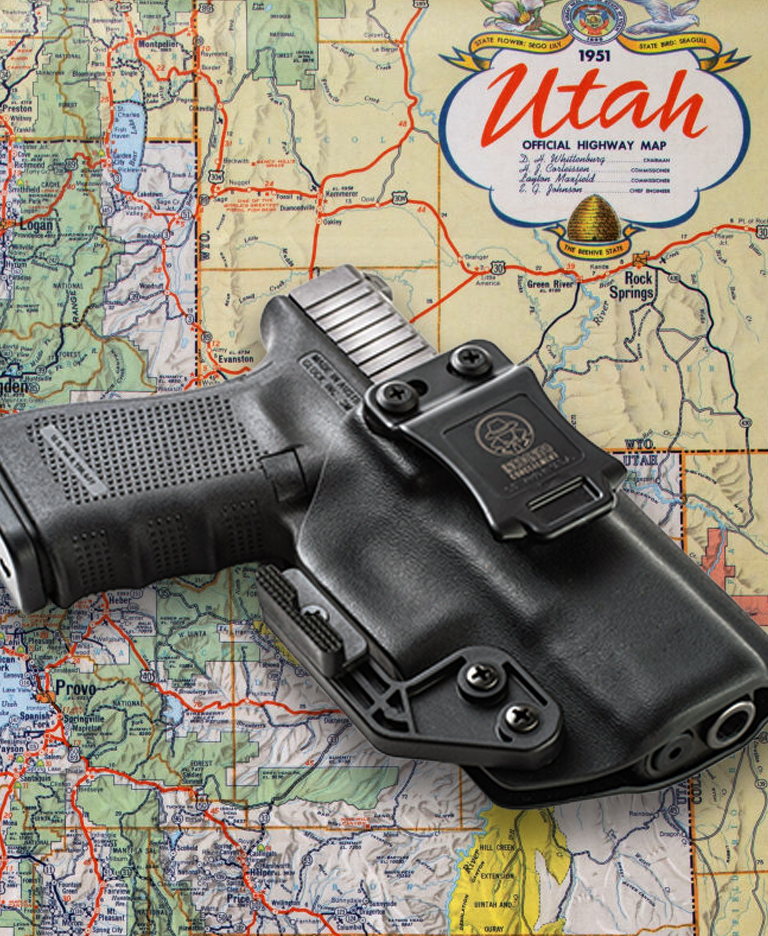 Map of Utah with a handgun laying on top of it