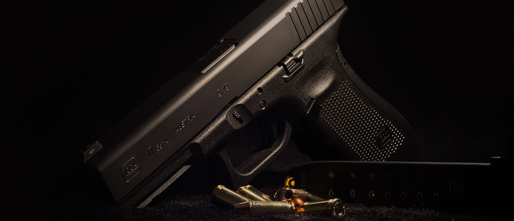 Dark handgun on moody, dark background